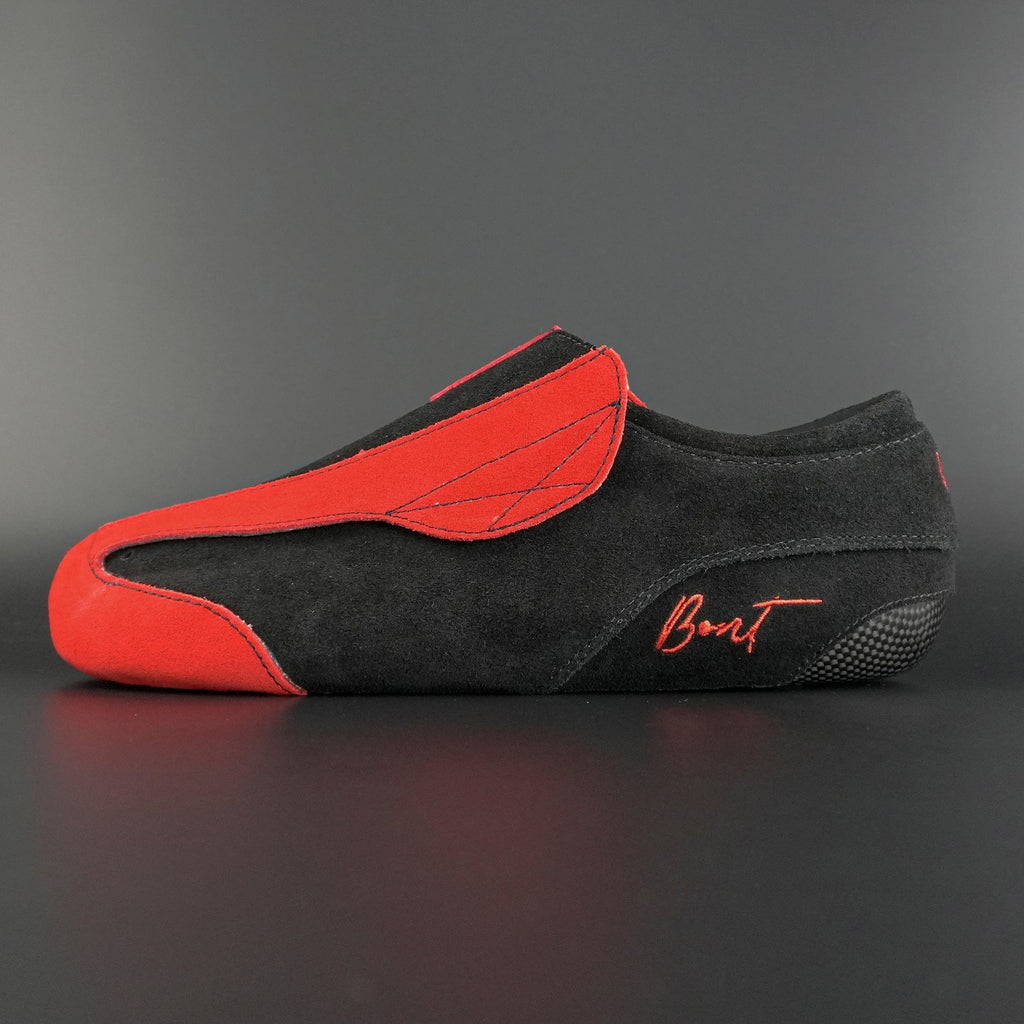 Side view of the Envy suede skate showing red and black suede finish