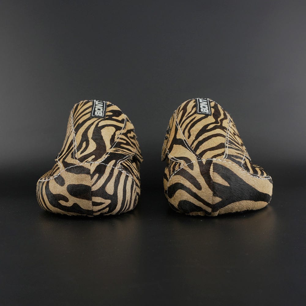 Skater wearing Envy Cow Zebra Print Style Roller Skates in motion